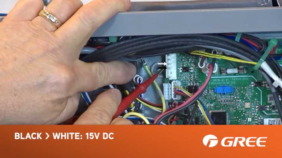 Testing black to white wire connection showing 15V DC reading on GREE FLEXX air handler control board